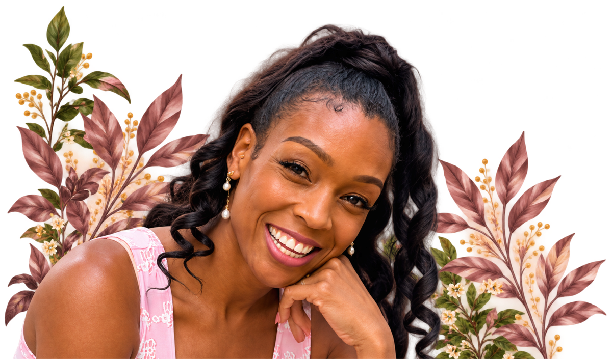 Ten Elyse smiling warmly with her chin resting on her hand, in a pink top, framed by blush leaves.